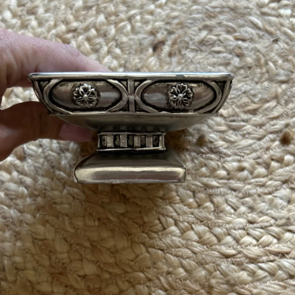 decorative silver-tone pedestal dish, likely used as a soap dish, trinket holder